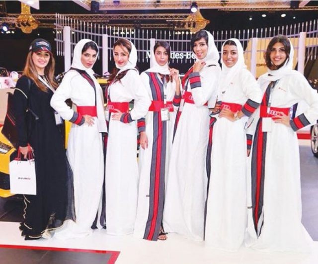 Modelo posam ao lado de carro de luxo no evento em Jeddah (Crédito: Reprodução)