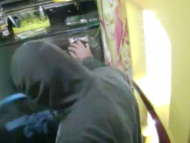 Bandido faz carinho na cabeça de criança (Crédito: Reprodução)