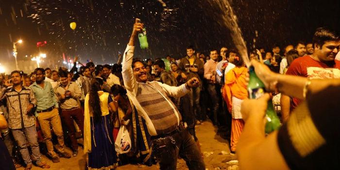 Pessoas dançam e fazem festa durante chegada do Ano Novo em Mumbai, na Índia
