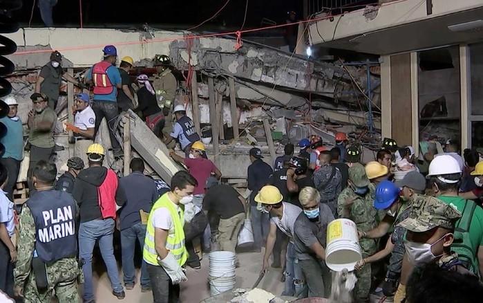 Equipes de resgate procuram crianças em escombros de escola que ruiu na Cidade do México (Crédito: AFP)
